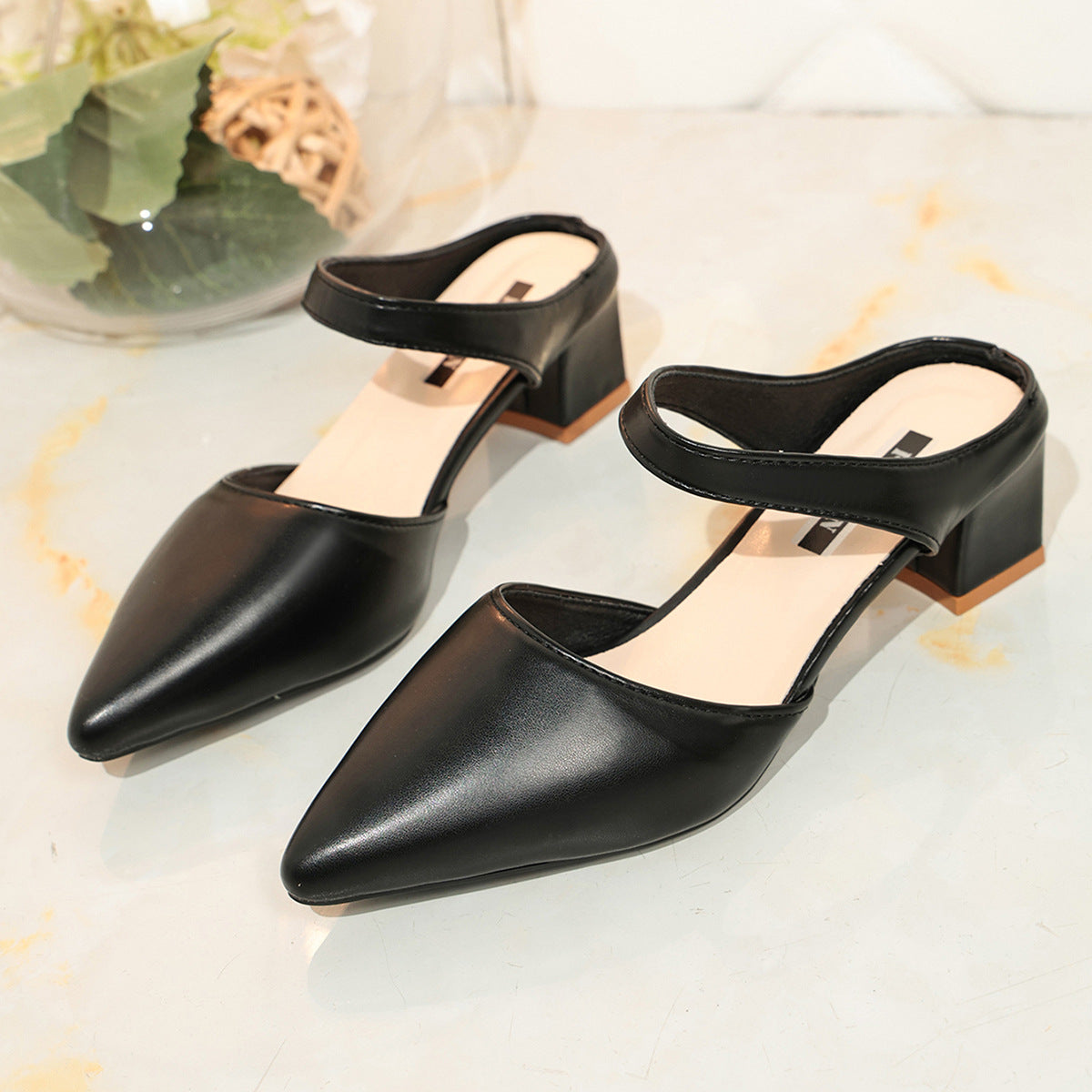 Black pointed-toe block heel mules with slingback strap, pair view
