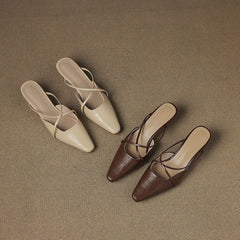 Beige and brown leather mules with crisscross straps, pointed toe, low heel