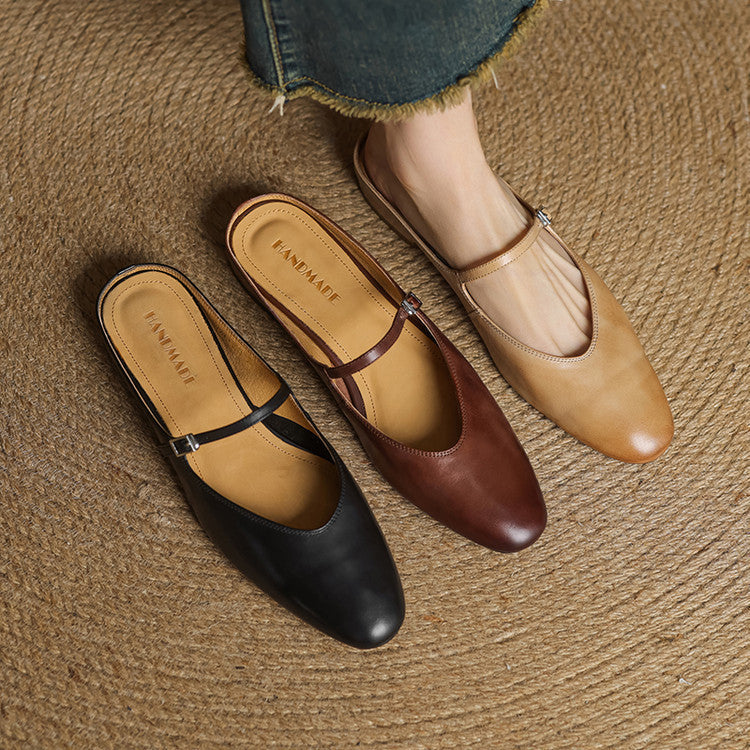 Genuine leather mules pair in black and brown and tan, each with buckled strap