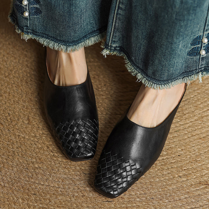 Black woven leather mule slides with square toe and low heel, open back