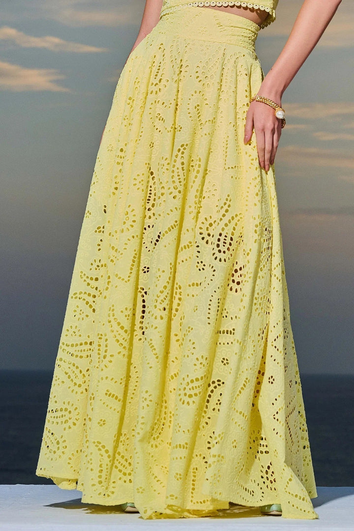 Women’s eyelet sleeveless maxi dress set in yellow, full skirt with lace cutouts.