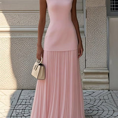 Pink pleated sleeveless maxi dress with fitted bodice and tiered skirt.