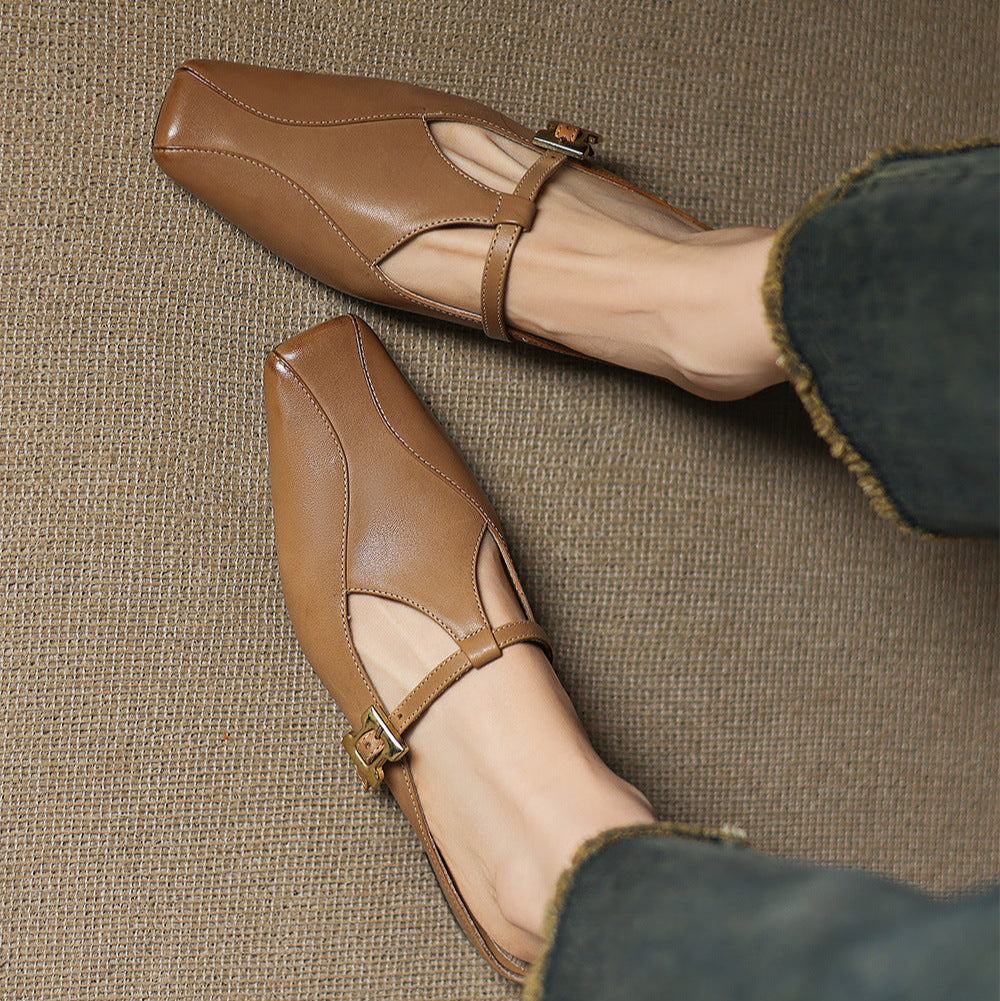Brown leather mules with ankle strap, cutout vamp, and gold buckle detail
