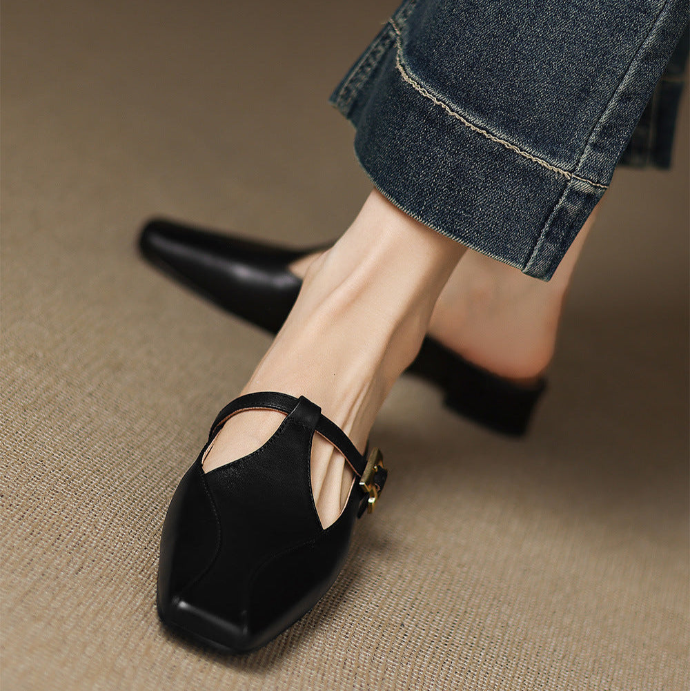 Black leather mules with open toe cutout and ankle strap, low heel view