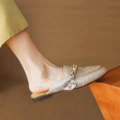 Beige genuine leather mules with floral print, braided bow ornament, low flat sole