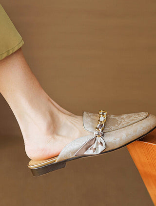 Beige genuine leather mules with floral print, braided bow ornament, low flat sole