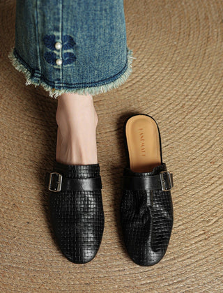 Black leather mules with square buckle strap and closed toe
