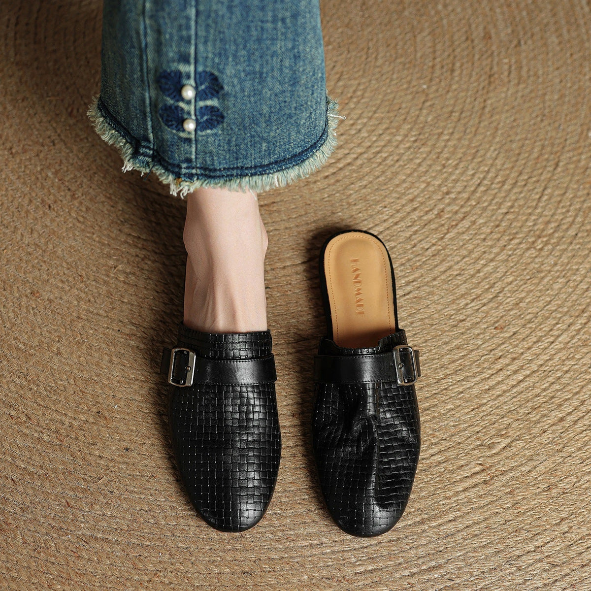Black leather mules with square buckle strap and closed toe