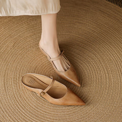 Tan leather mules with pointed toe, slim ankle strap, and buckle detail