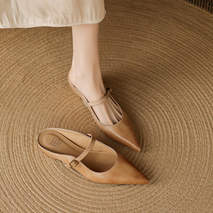 Tan leather mules with pointed toe, slim ankle strap, and buckle detail