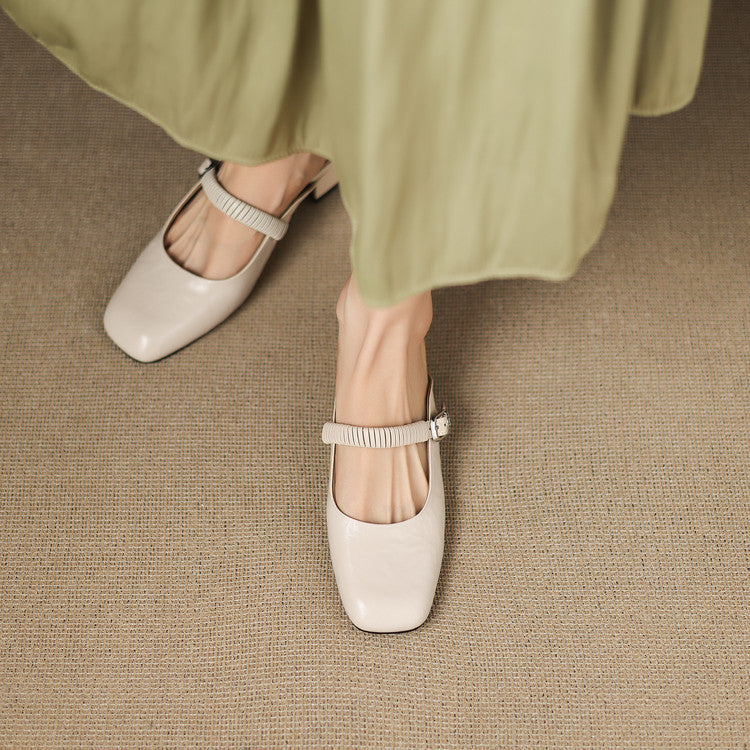 Beige leather Mary Jane mules with elastic strap and low block heel on feet