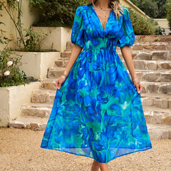 Blue floral midi dress with V-neck, puff sleeves, and elastic gathered waist