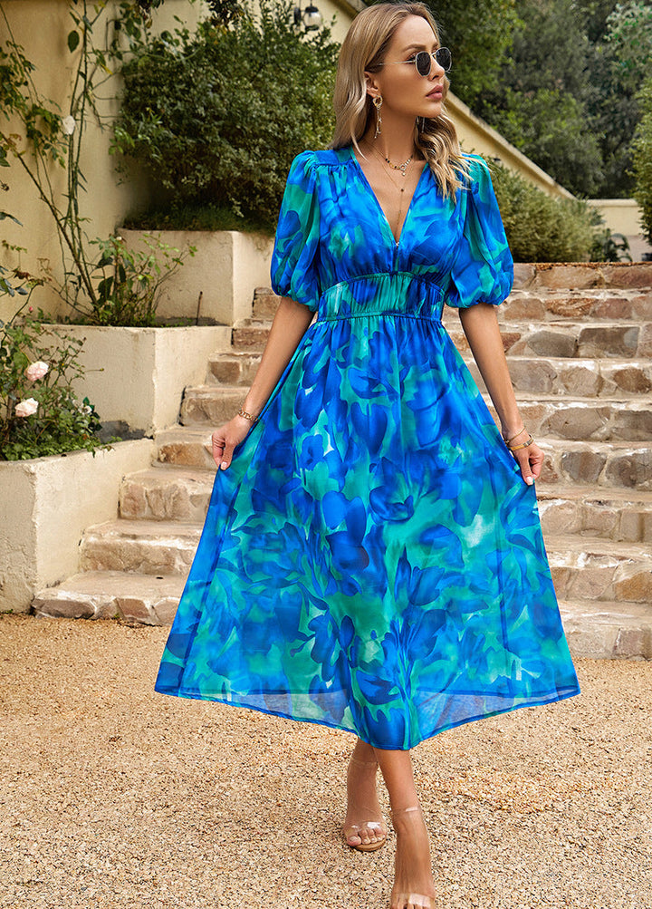 Blue floral midi dress with V-neck, puff sleeves, and elastic gathered waist