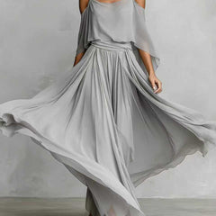 Light grey draped cold-shoulder maxi dress with cape sleeves and gathered pleated skirt