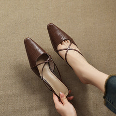 Brown genuine leather mules with crisscross straps and mid block heel, side-by-side view.