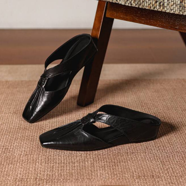 Black square-toe leather mules, slip-on style with knotted detail on the vamp.