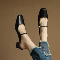 Black genuine leather mules with square toe, sling strap, and block heel, side view