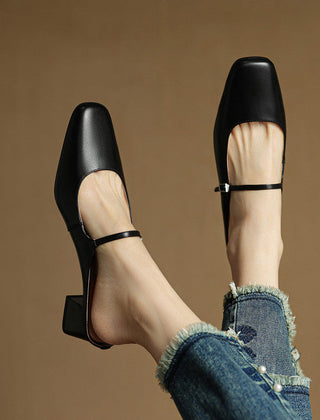 Black genuine leather mules with square toe, sling strap, and block heel, side view