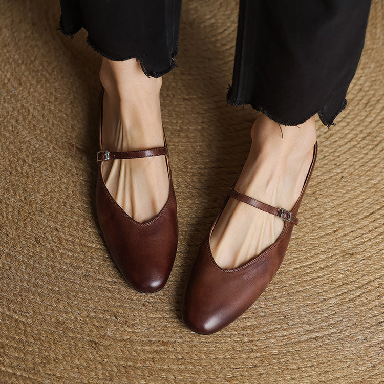 Brown genuine leather ballerina-style mules with cross strap buckle and low heel