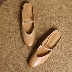 Apricot genuine leather slip-on mules with adjustable strap and buckle detail