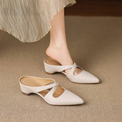 White pointed-toe mules with cross-strap cutout and low block heel