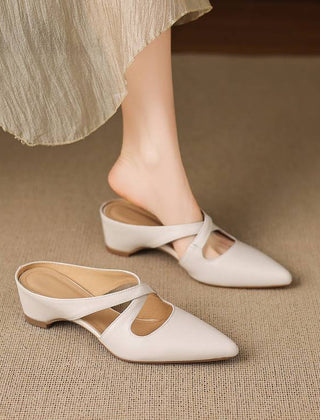 White pointed-toe mules with cross-strap cutout and low block heel