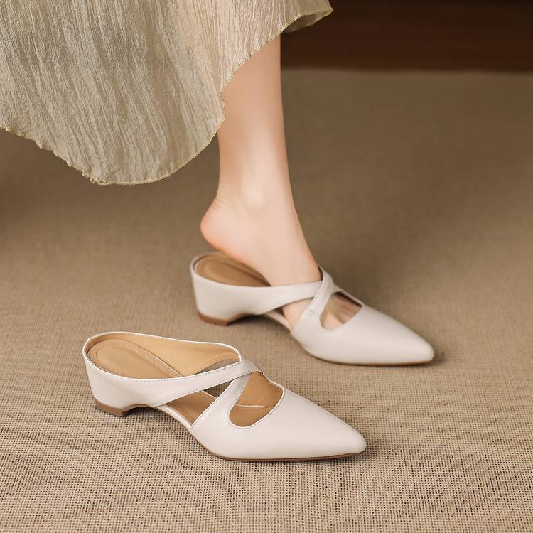 White pointed-toe mules with cross-strap cutout and low block heel
