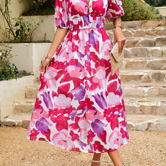Pink floral midi dress with puff sleeves, V-neck, and tied waist