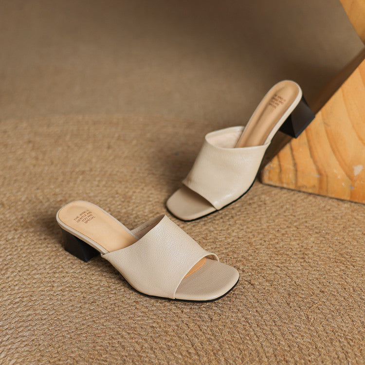 Beige open-toe leather mules on low block heels, slip-on design