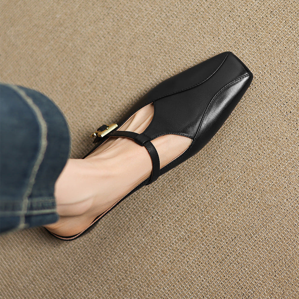 Black leather mules with open toe strap and gold buckle on low block heel