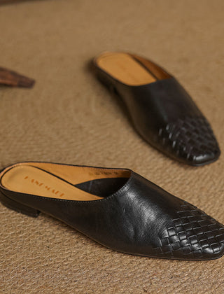 Black leather mule with woven toe panel and low flat heel