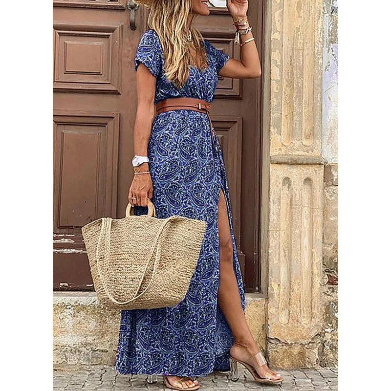 Blue patterned maxi dress with short sleeves, side slit, and brown waist belt