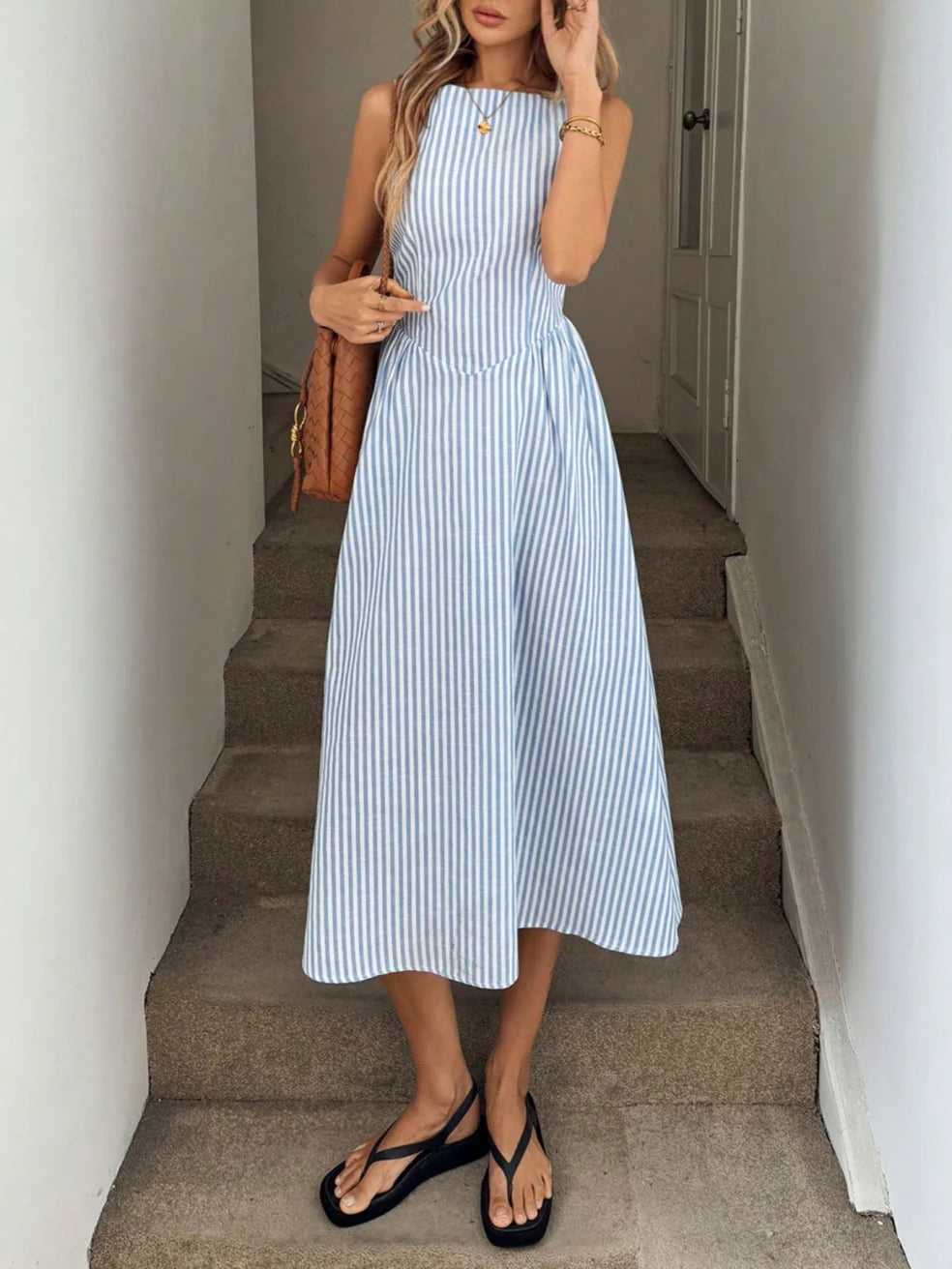 Blue striped sleeveless maxi dress with fitted waist and flared midi skirt