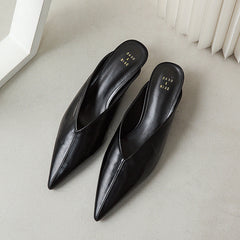 Black pointed-toe mule shoes with slip-on design, pair shown from above