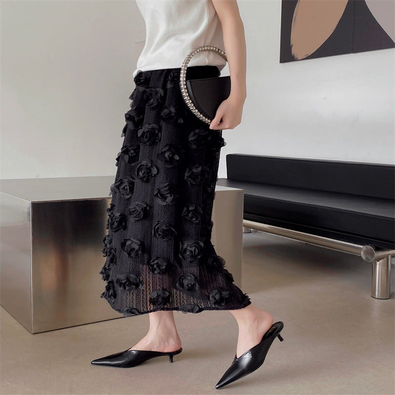 Black pointed-toe mules with low heel, side view on model’s feet