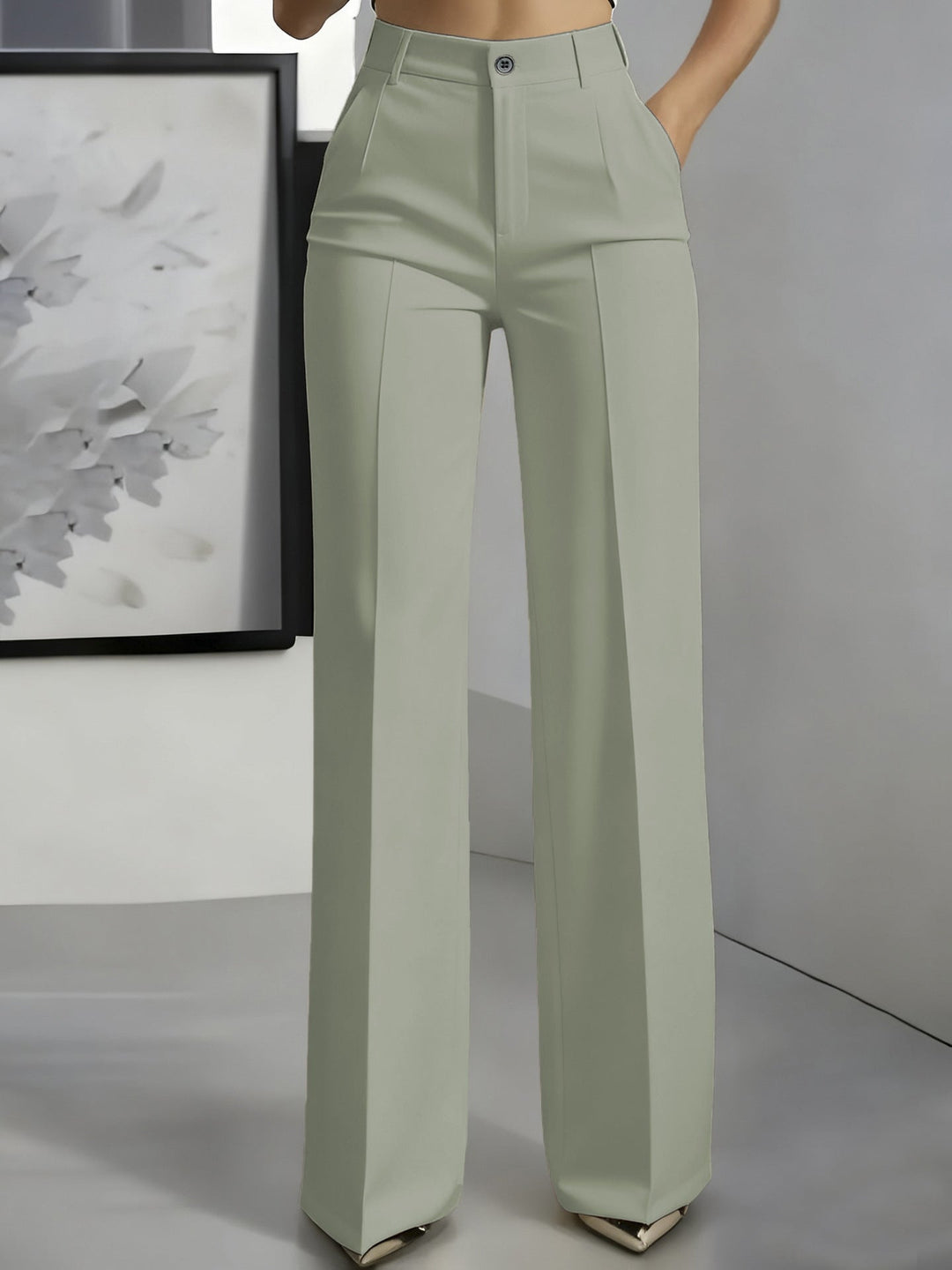 Sage green high-waisted straight-leg trousers with front button and pressed creases