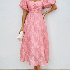 Pink off-shoulder midi dress with short puff sleeves and textured ruched fabric