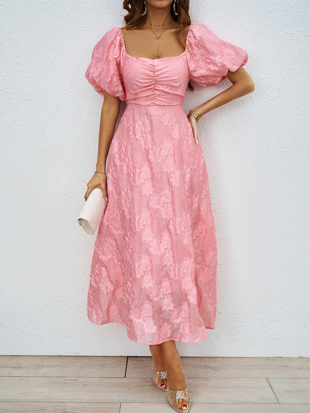 Pink off-shoulder midi dress with short puff sleeves and textured ruched fabric
