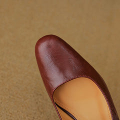 Maroon leather mule with open sling and tan insole, close-up upper