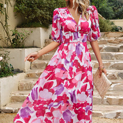 Pink and white floral midi dress with V-neck, puff sleeves, and gathered waist