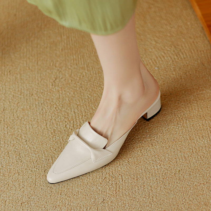 White leather pointed mule with strap detail and low block heel, front angle