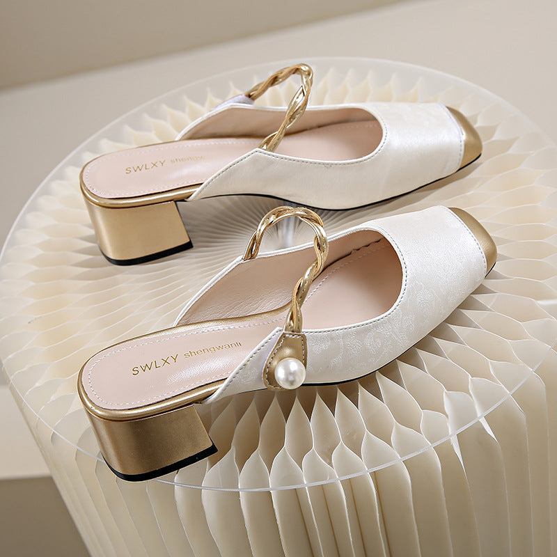 White genuine leather mules with gold block heel and chain slingback strap, pearl ornament.