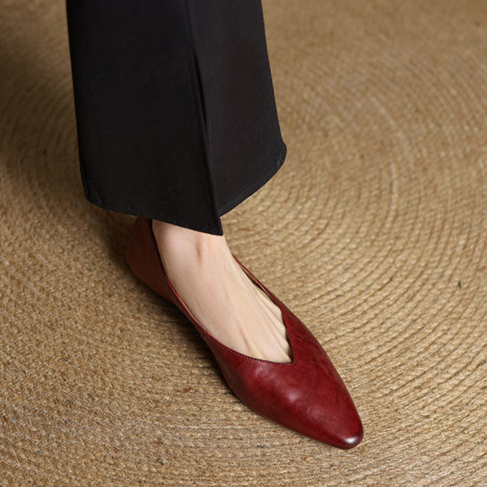 Maroon leather pointed-toe mules with low heel, angled side view