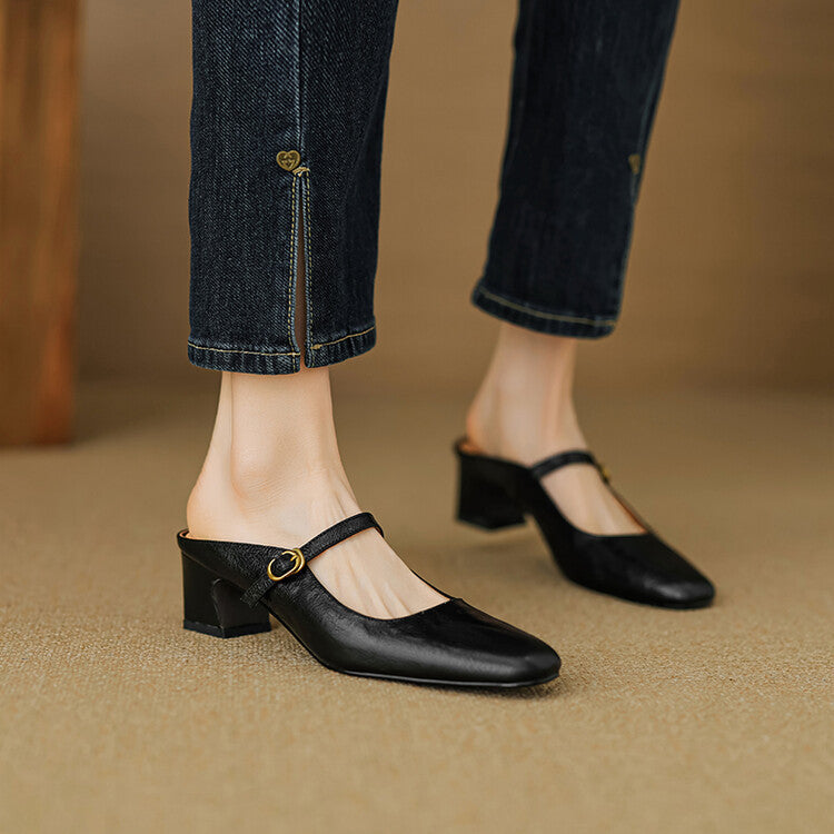 Black leather mules with rounded toe, low block heel, and oval buckle strap
