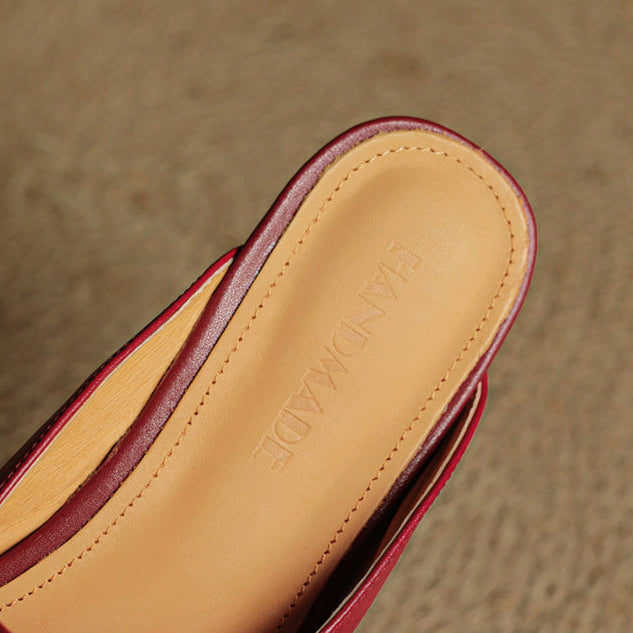Maroon leather mules close-up of tan insole and side seam stitching
