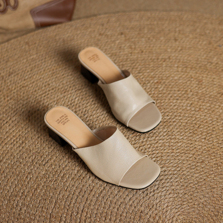 Beige leather mule slides with open toe and low block heel, slip-on