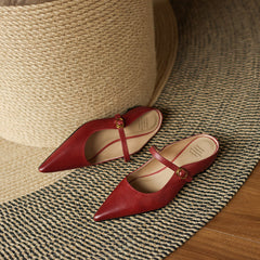 Maroon leather mules with pointed toe, slingback strap, and low block heel, side view
