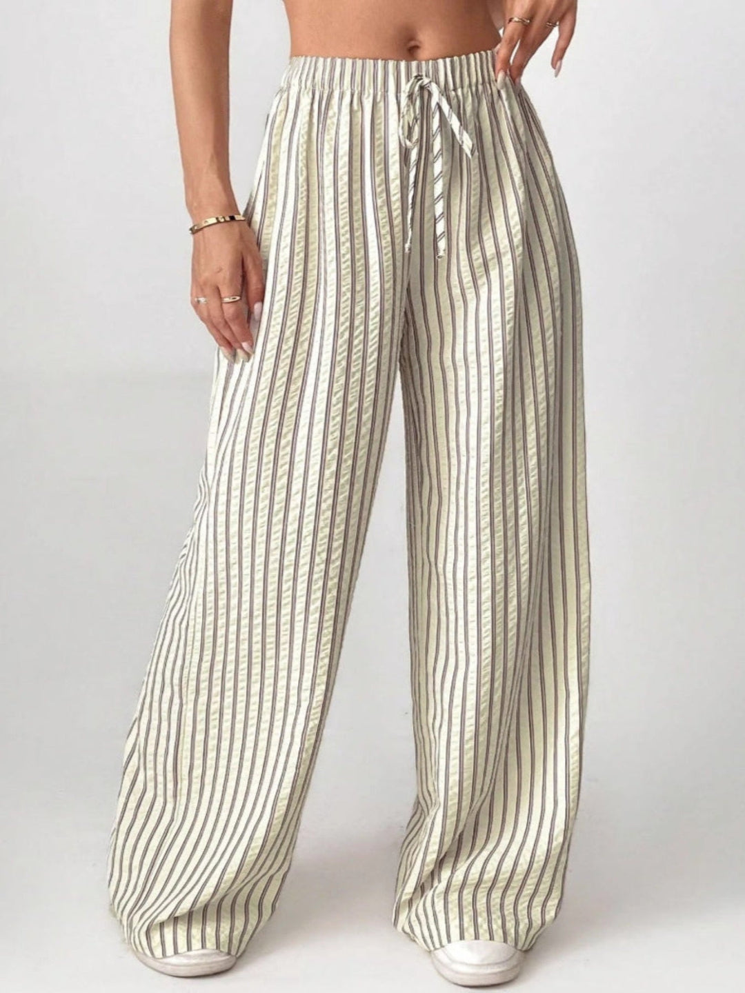 Cream striped trousers with drawstring waist and wide, flowy legs