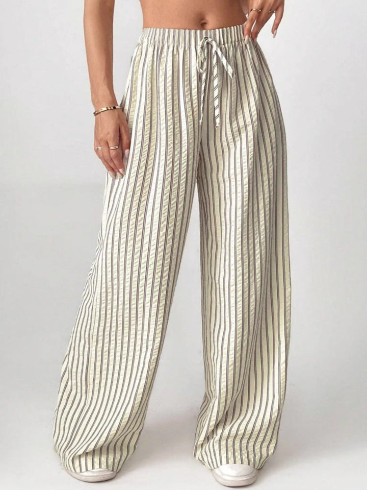 Cream striped trousers with drawstring waist and wide, flowy legs