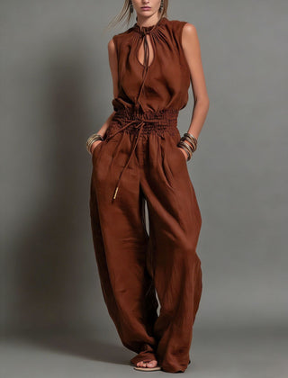 Rust brown halter wide-leg jumpsuit with tie neckline and elastic waist drawstring